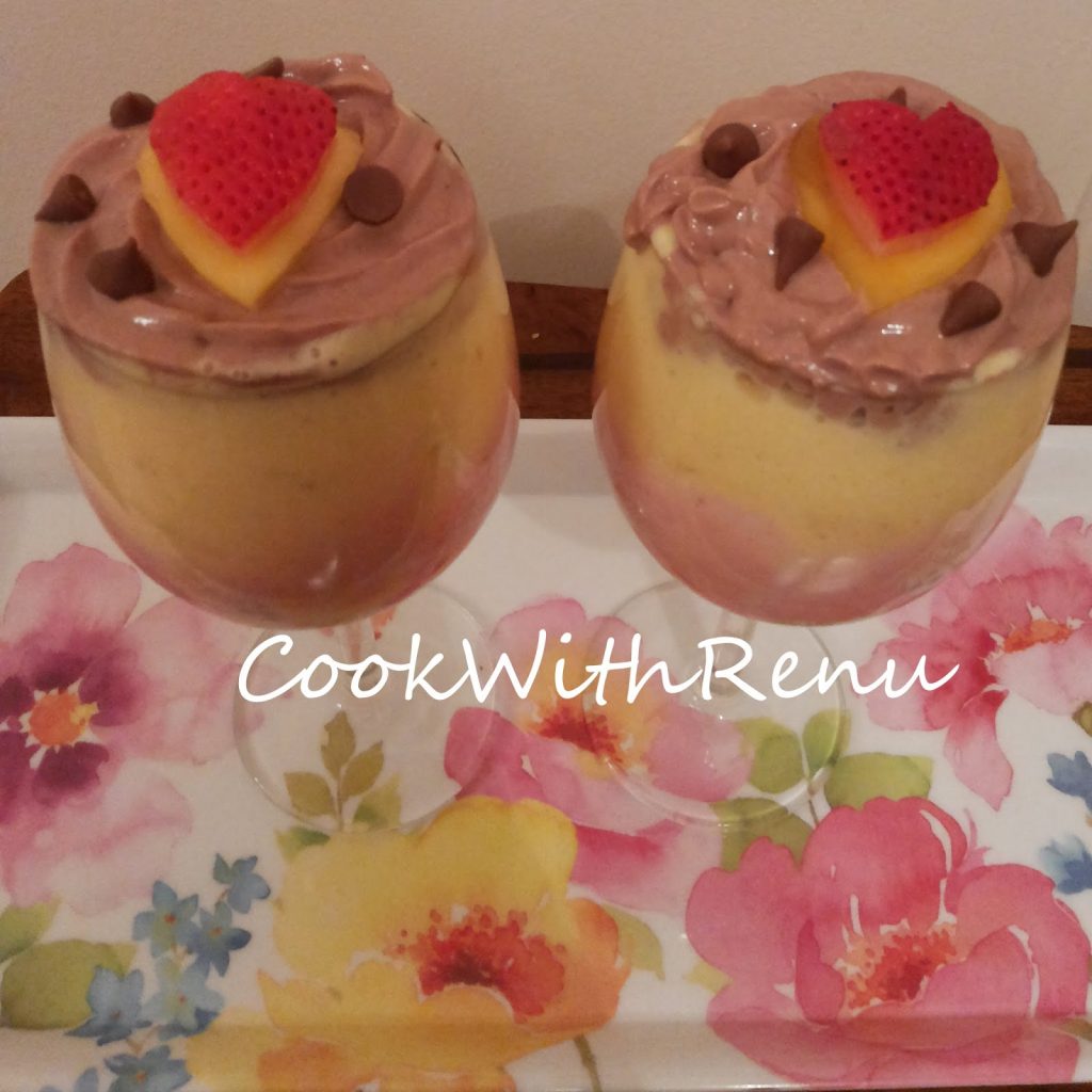 Chocolate and Mango Yogurt served in 2 glasses, garnished with fruits and choco chips