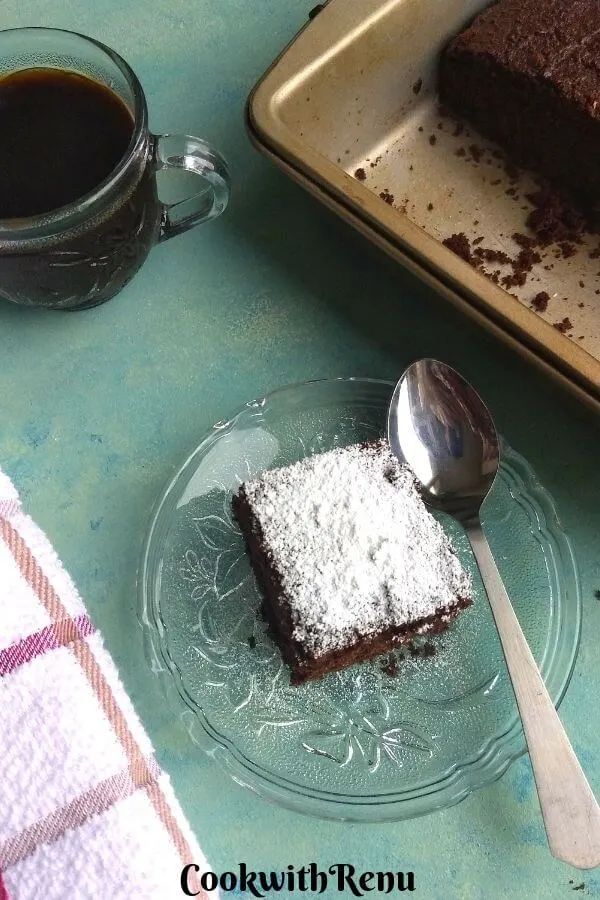 Low Carb Chocolate Coconut Flour cake slice served on a plate with icing on top, served with Black coffee.