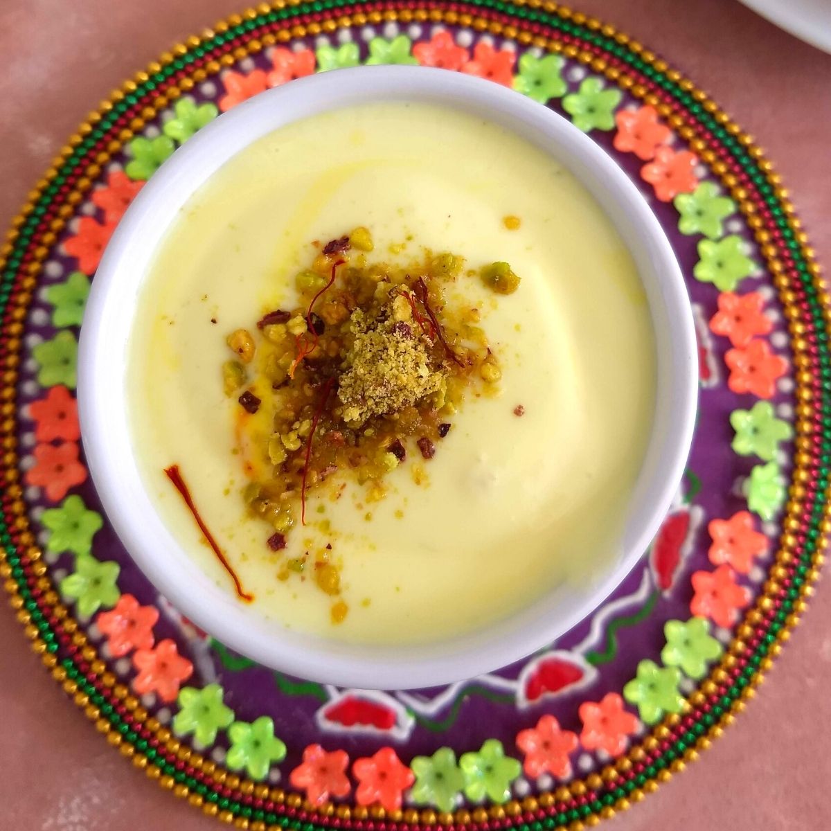 Shrikhand served in a bowl with a generous garnish of kesar and elaichi