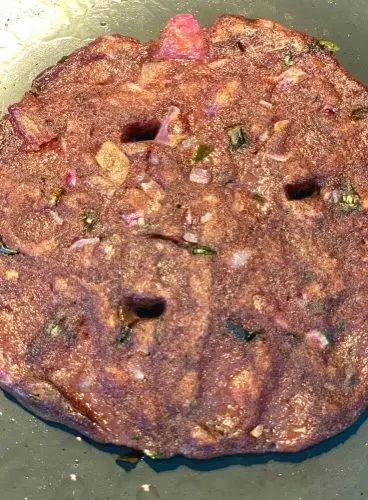 Ragi roti being cooked on a griddle/tava