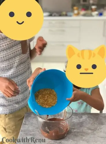 Kids adding the cornflakes into melted chocoalte
