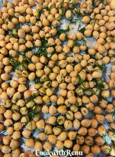 Chickpeas Coated with Herbs, Oil and Salt and layered on a baking tray