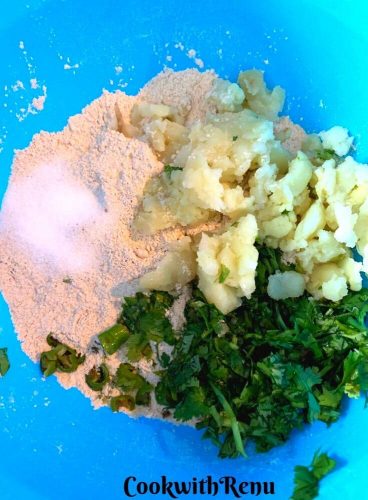 Flour, mashed potatoes, salt, coriander and chilies added into the bowl