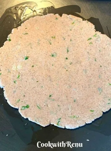 Rolled flatbread ready to cook on a tava