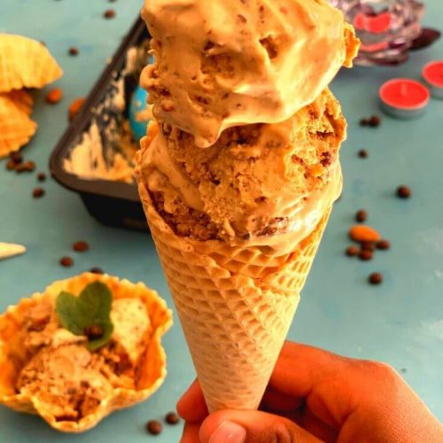 Ice cream presented in a waffle cone with 2 huge scoops of Ice Cream