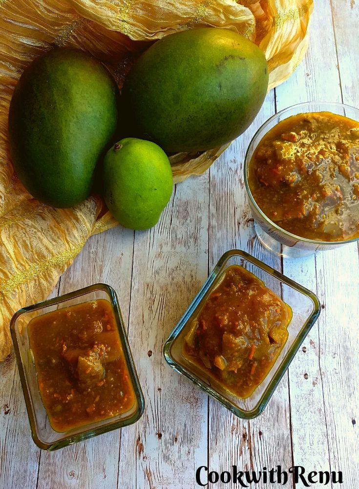 Kairi ki launji being presented in 2 rectangular bowls and 1 circular with 2 big sizes and 1 small size Kairi or raw mango in the background