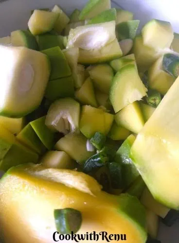 Raw mango cut into small cubes and green chilly into small pieces