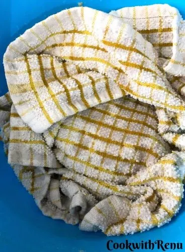 Dough covered with clean kitchen towel