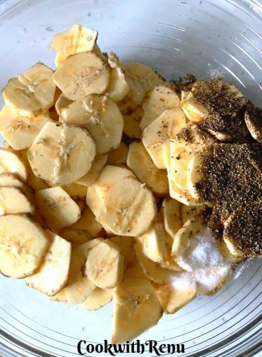 Banana Slices with oil, salt and pepper ready to be mixed in a bowl
