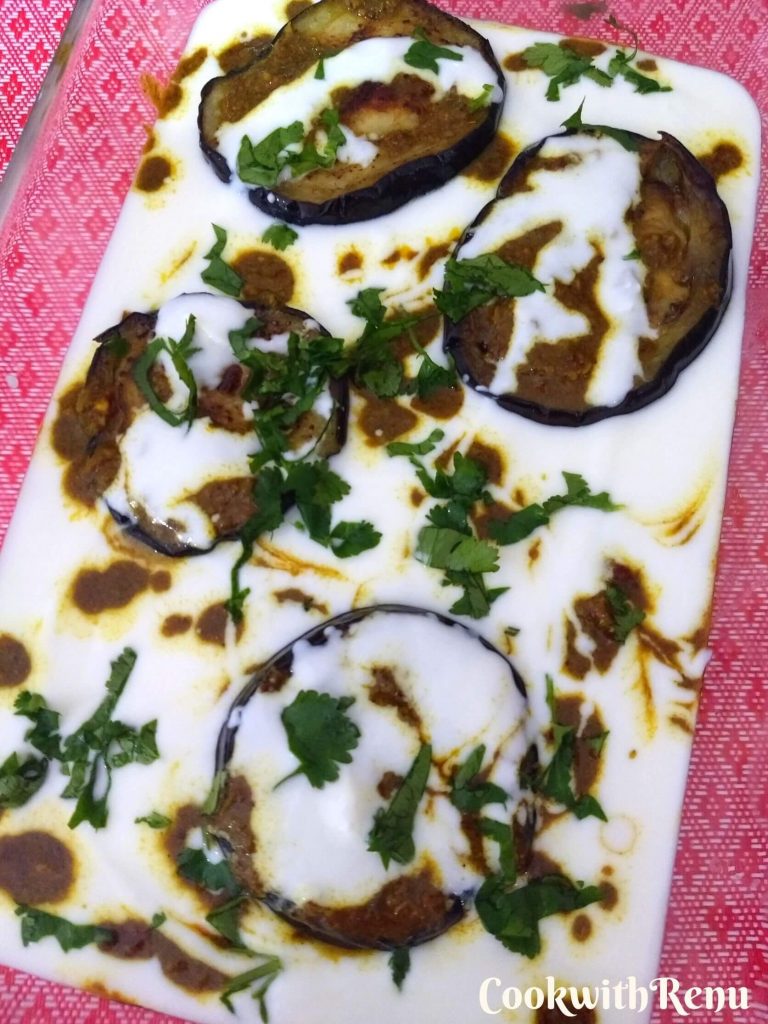 Dahi wale Baingan being served in a tray garnished with coriander