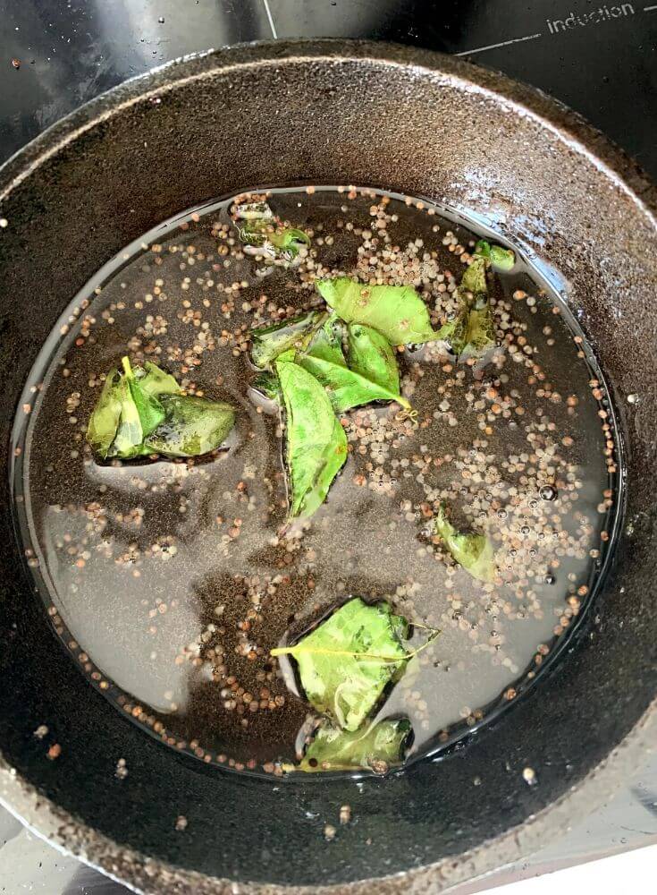 Tempering with oil, mustard seeds and curry leaves