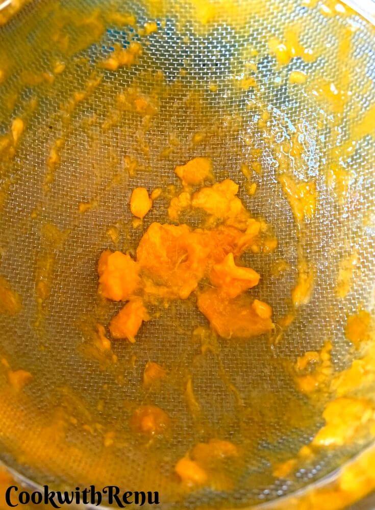 The pulp being strained using sieve