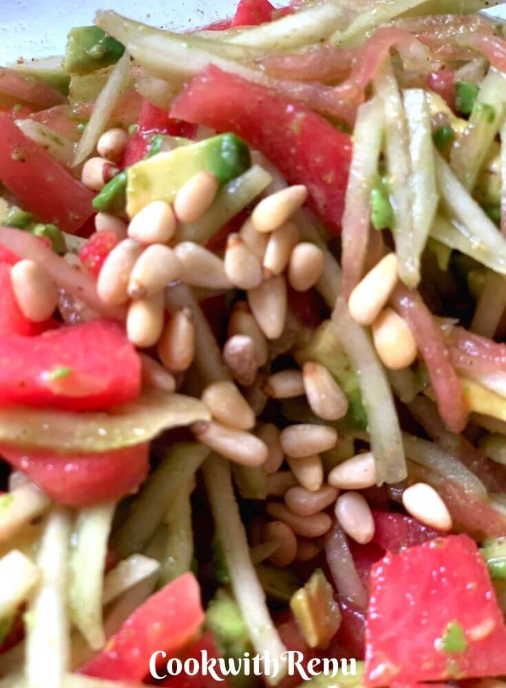 Adding of Pine nuts in the salad