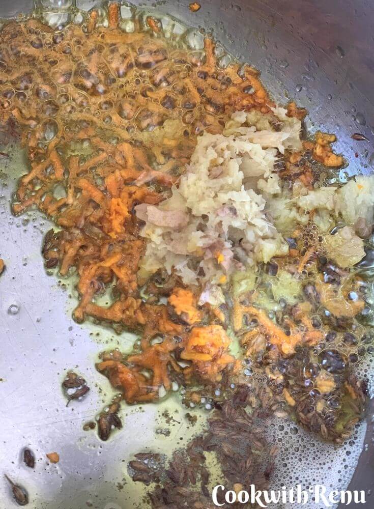 Adding of fresh grated ginger and fresh grated turmeric in the ghee and Jeera mixture