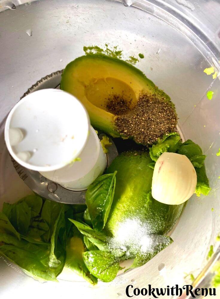 Adding the ingredients in a food processor, Avocado, Basil, Garlic, Lemon Juice, Salt and Black pepper