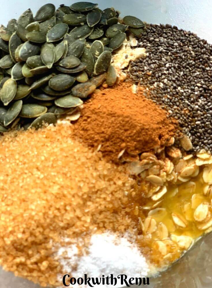 The mix in a bowl, with oats, sugar, sunflower seeds, chia seeds, cinnamon and butter