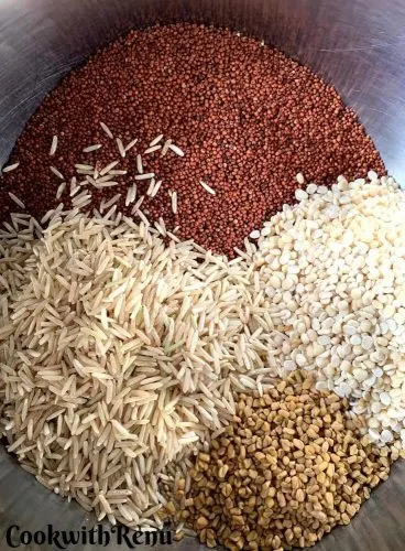 Whole Ragi seeds, Rice, Urad Dal and Fenugreek Seeds taken in a bowl