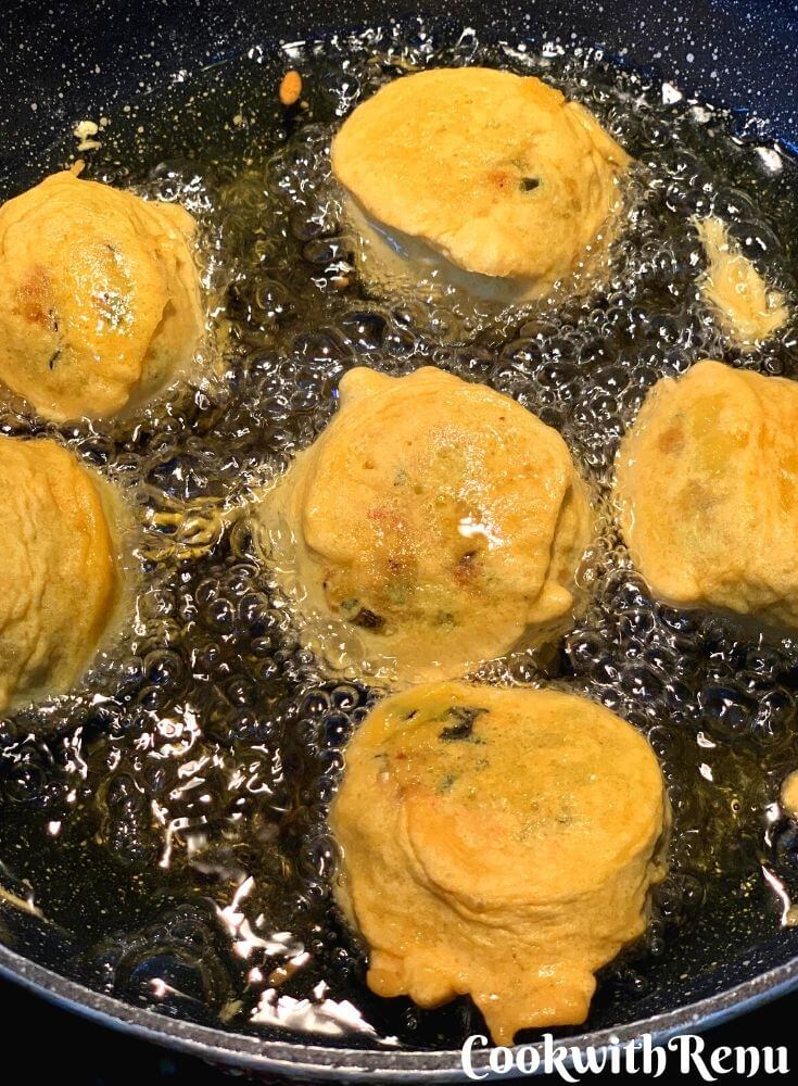 Frying of the vada , they are frying on the other side