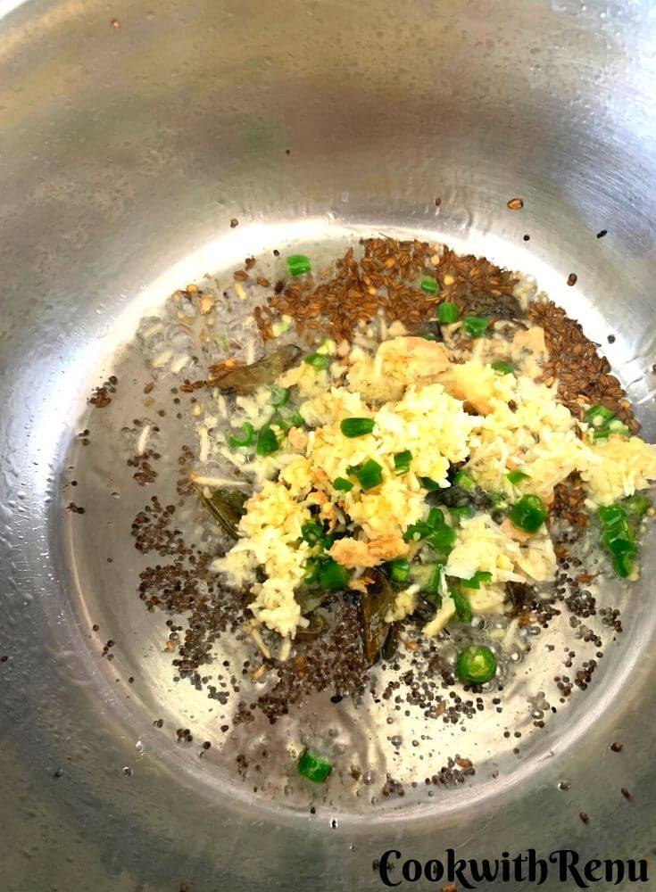Ginger, garlic and green chilies being added in the tempering