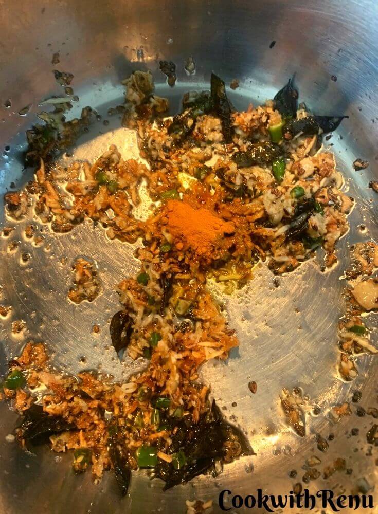 Turmeric being added in the tempering