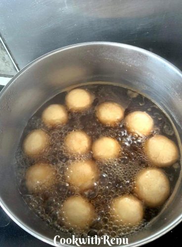 Making of Rasgulla in open pan , the syrup is brown due to Dermera Sugar