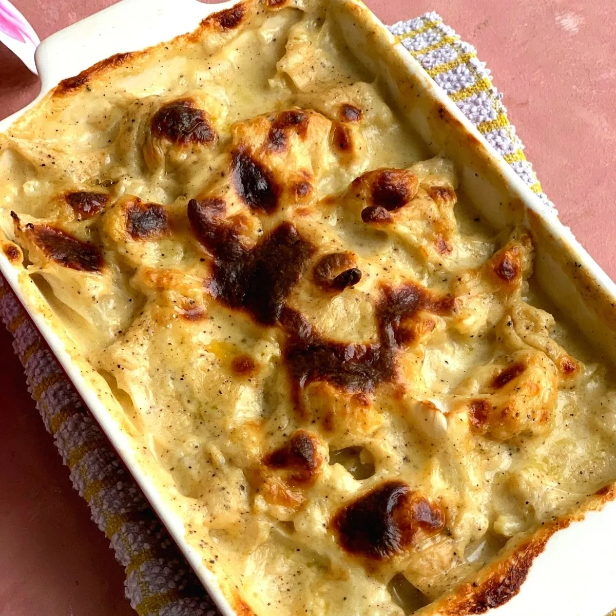 Easy Cauliflower Gratin is a delicious cheesy bake made using low carb cauliflower and the topped perfectly browned using flour, milk, and cheese.