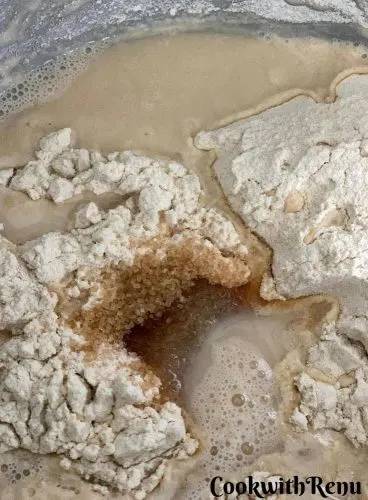 Adding of water and sugar to the flour