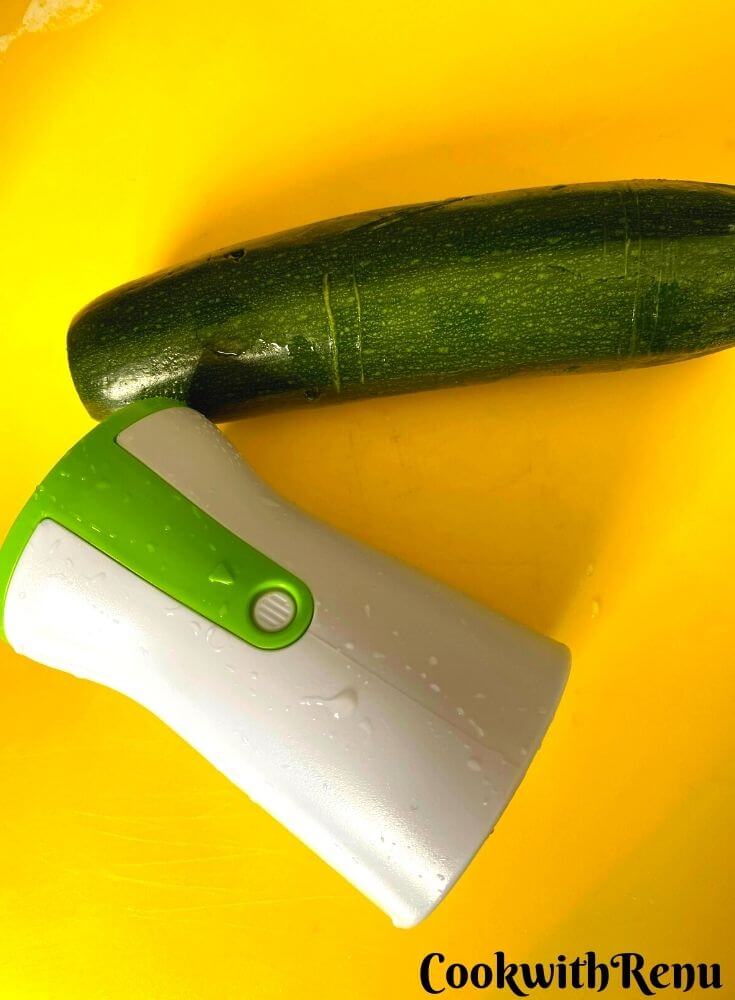 Clean and washed zucchini, with ends trimmed. Hand Spiralizer kept in the background