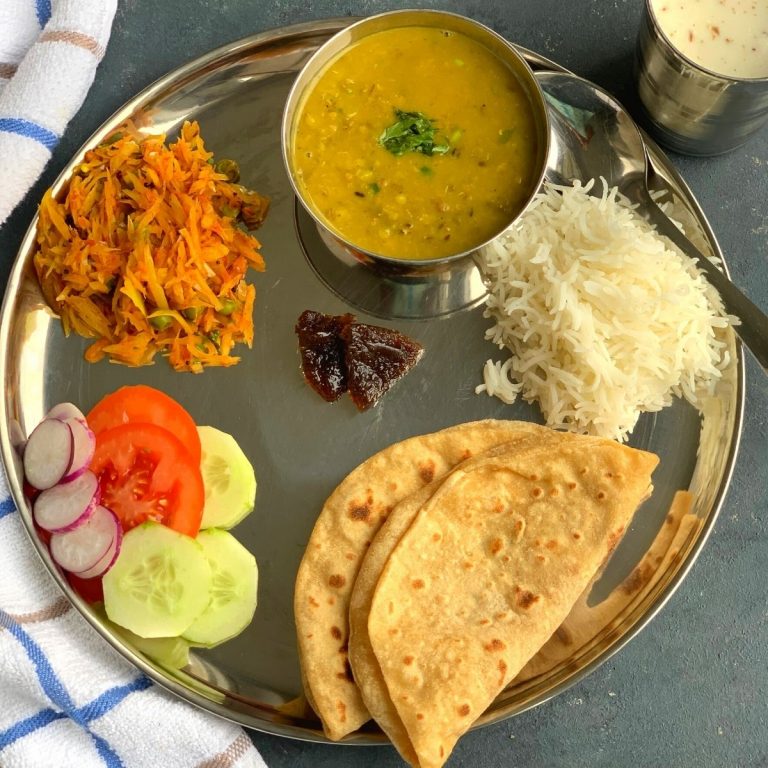 A North Indian Vegetarian lunch thali is a No onion No garlic, simple everyday balanced meal of proteins and carbs from nutritious dal, vegetable, salad, roti and rice.