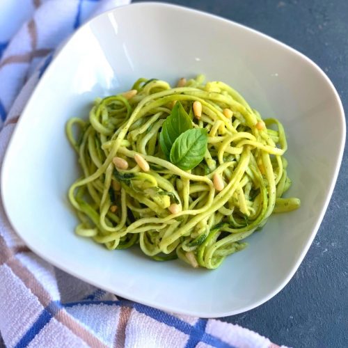 Close up view of Raw Zoodles Salad or Zucchini noodles or Courgette noodles are no cook, low carb, vegan and gluten free vegetarian noodles made using Zucchini and a perfect alternative to pasta. This Zucchini pasta with Avocado Basil Dip is a perfect no cook and keto friendly healthy lunch.