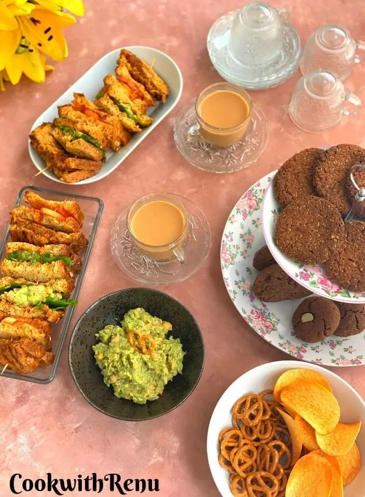 Afternoon Tea Time Platter featuring different types of Vegan Sandwiches, Gluten-Free and nut-free cookies, chips, and dips catering to people with different food groups.