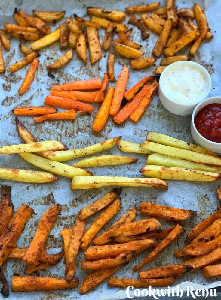 Crispy Baked French Fries of Oven chips are a guilt-free snack or a side which are baked in the oven until crisp with just a teaspoon of oil. Served with tomato ketchup and creamy garlic dip