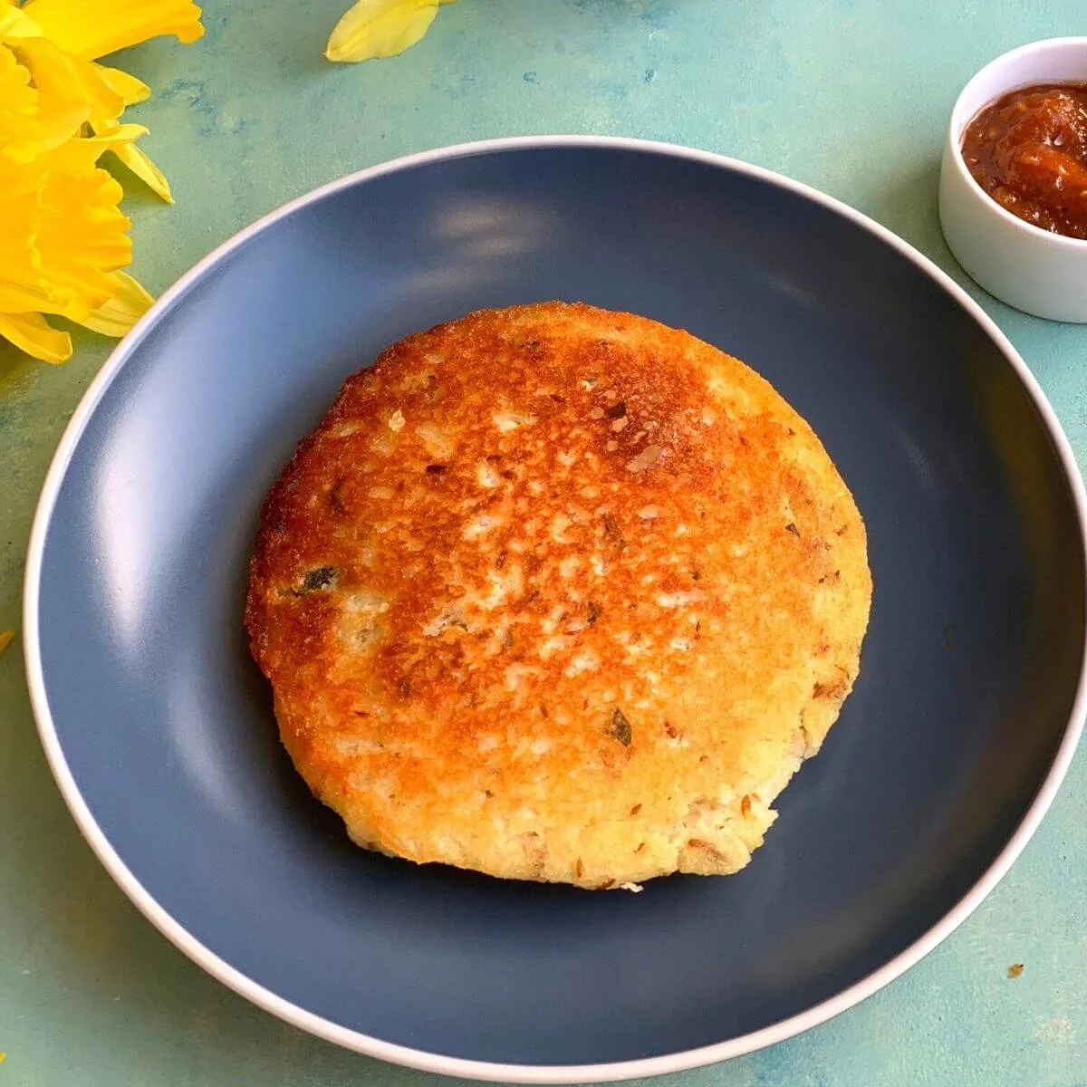 Dibba Rotti is a thick and crusty bread made using Rice Rava and Urad dal and generally served for breakfast or snack.
