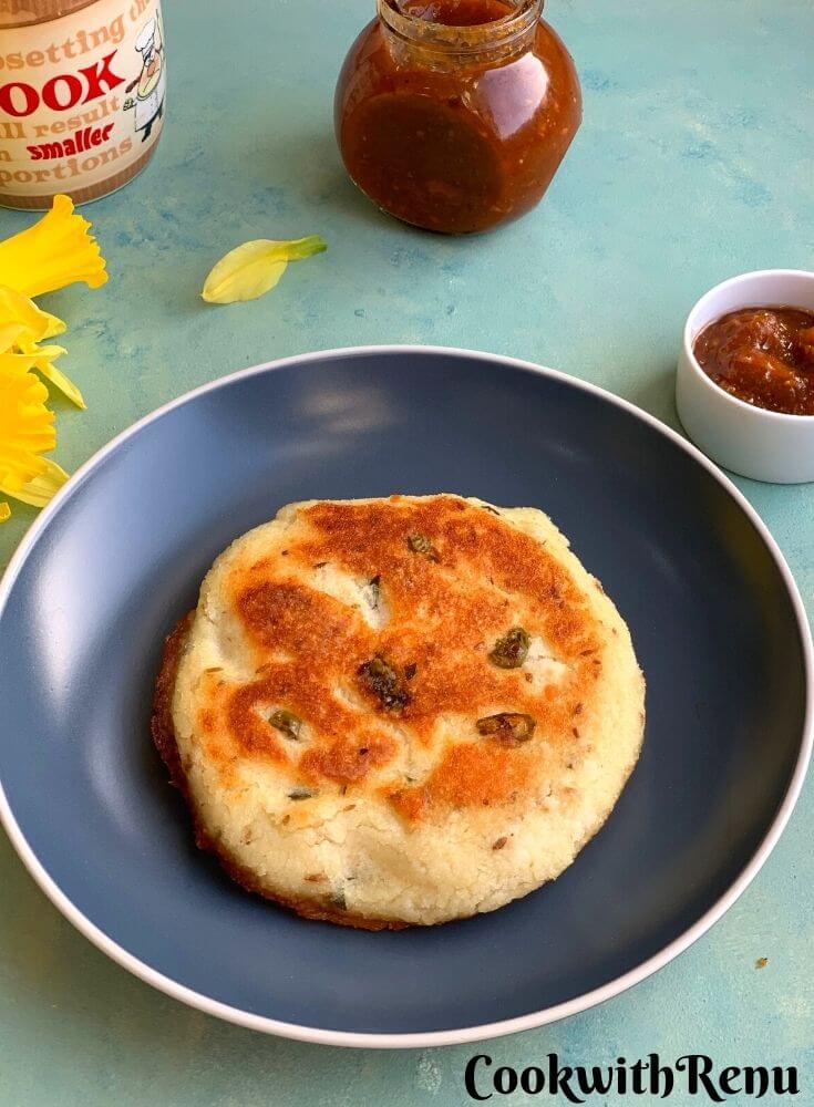 Bottom look of Minapa rotti, looks nice and crisp served on a blue plate with tomato chutney