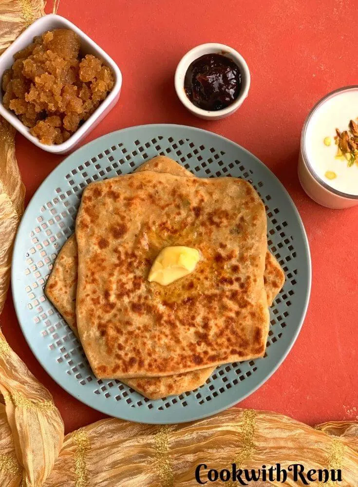 Easy Mooli Paratha served with a dollop of butter, no oil lemon pickle, Sweet Lassi (Yogurt drink) and Ate ka halwa/karah Prasad