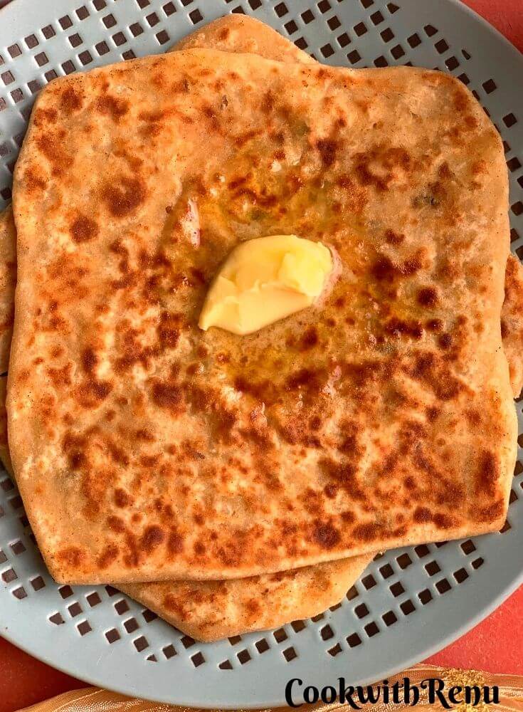 Close up look of Radish Paratha, with a dollop of butter