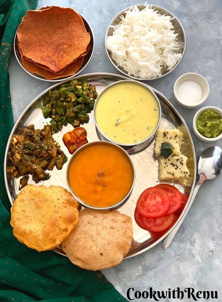 Gujarati Thali is a spectacular treat and fusion of sweet, salty, and spicy flavors all combined in a classic Indian Regional thali.