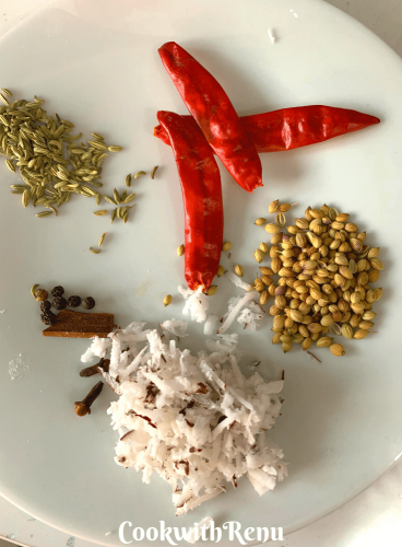 Ingredients for the masala paste, seen are red chilly, fennel seeds, coriander seeds, fresh grated coconut, 5-6 peppercorns, 2 cloves