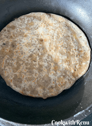 The bottom of the flatbread being cooked