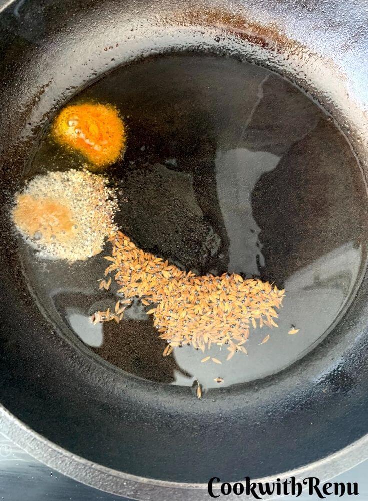 Adding of Asafoetida and turmeric powder