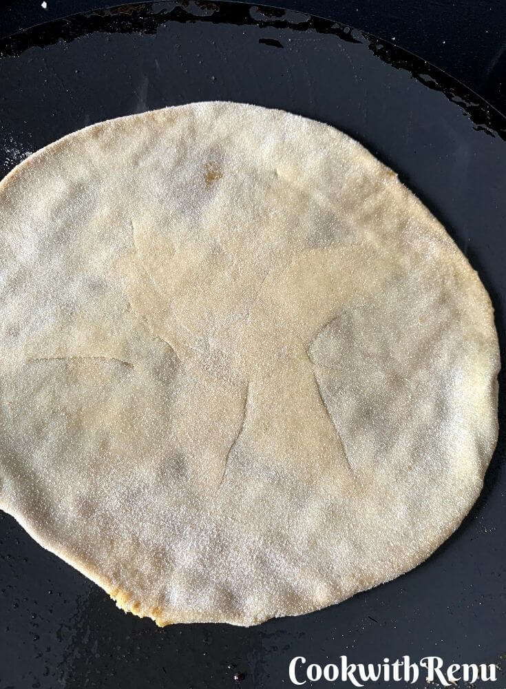 The initial cooking of the poli on he top side