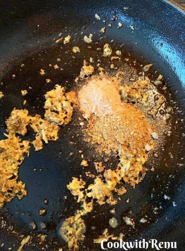 Adding amchur powder and coriander powder in the pan