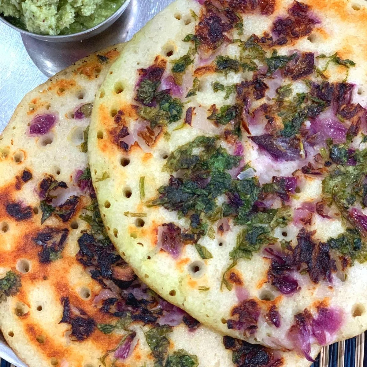 Onion Uttapam is an easy South Indian Breakfast Recipe or savoury pancakes that is made using fermented batter using Rice and Lentils.