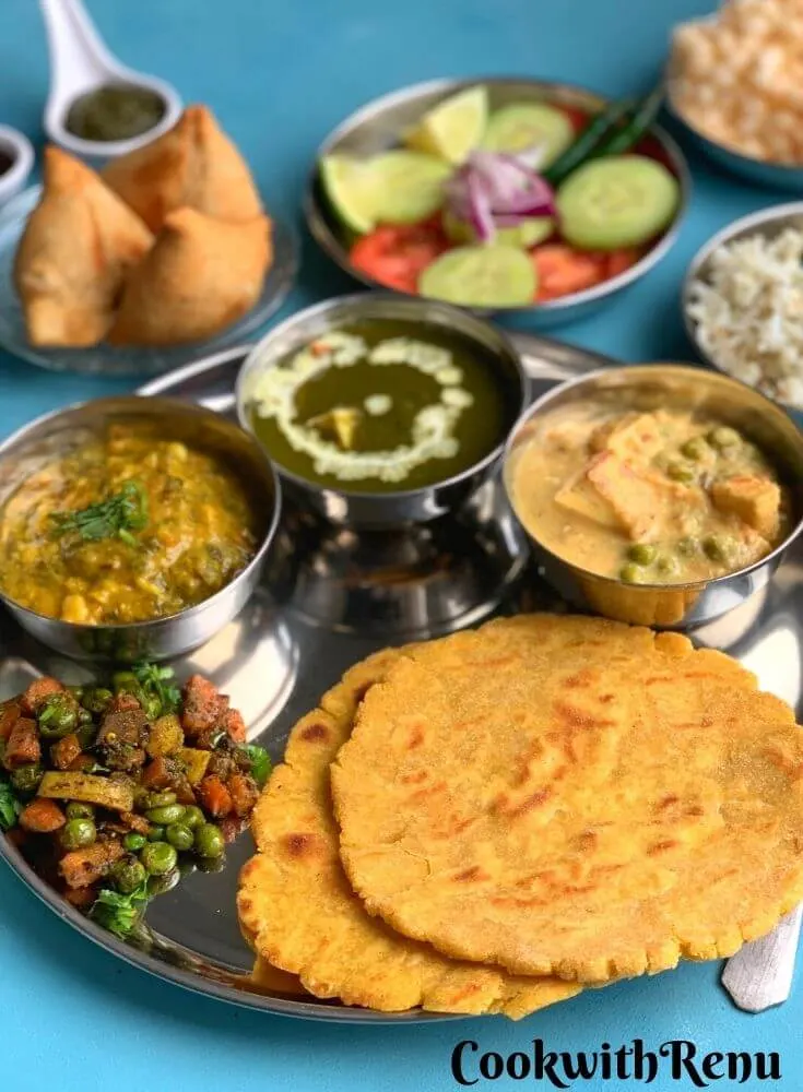 Another close up look of Punjabi Thali. Seen in the background are samosa, salad, rice and papad