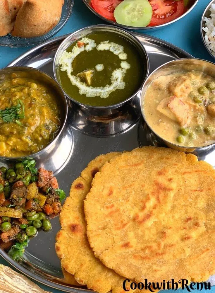 Close up look of Vegetarian Punjabi Thali, showcasing, makki di roti, and vegetables