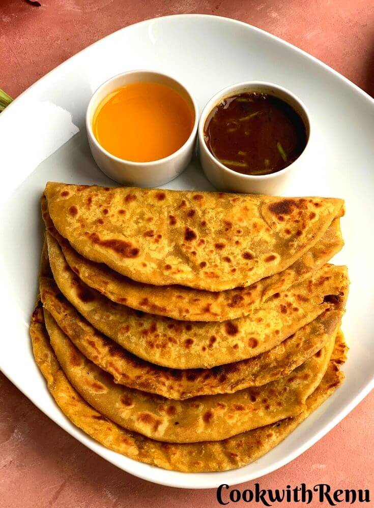 Three Puran Poli arranged on a white plate, served with ghee (Clarified butter) and katachi amtiPuran Poli is a delicious sweet Lentils Flatbread from the state of Maharashtra made during special occasions like Holi, Gudi Padwa etc.