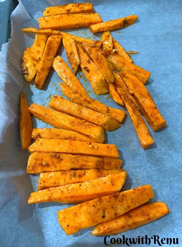 Sweet potatoes being seasoned with peri powder