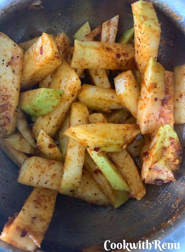 Turnip fries being coated with salt, oil and peri powder