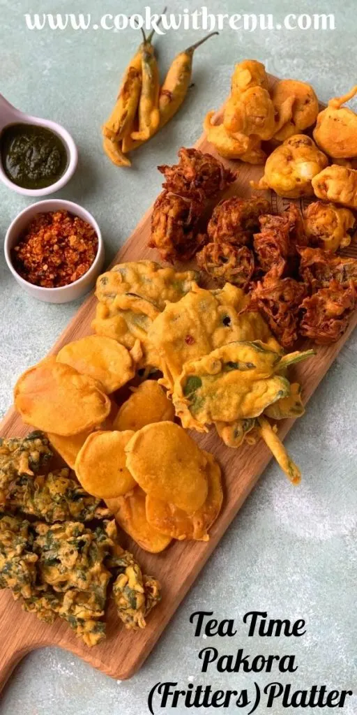 Tea time Pakora Platter is an addictive platter which has 6 different types of pakoras. They are yummy and crunchy snack or tea time fritters. Fritters are served on a wooden board with Coriander, Imli and Garlic chutneys on the side.