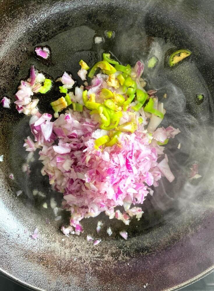 Onion and green chili cooked in oil